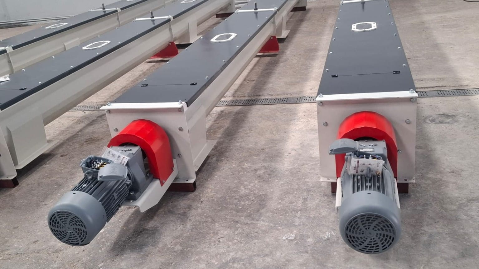 Motor end detail of ADDAMS screw conveyors with red drive guards
