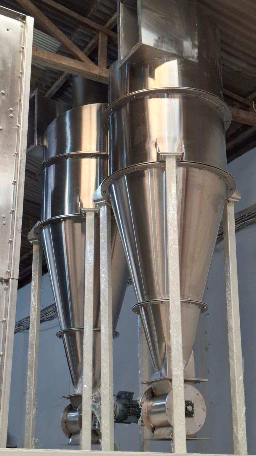 Two stainless steel cyclone separators with rotary discharge valves in the ADDAMS workshop