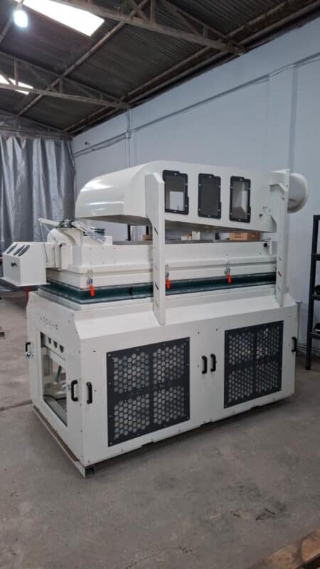 ADDAMS processing machine with upper aspiration housing, inspection windows and guarded lower panels in the workshop