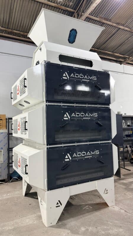 Front view of an ADDAMS three-module processing machine with feed hopper and inspection panels