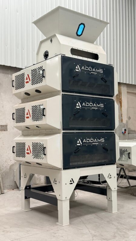 ADDAMS three-module processing machine with feed hopper and inspection panels in the workshop