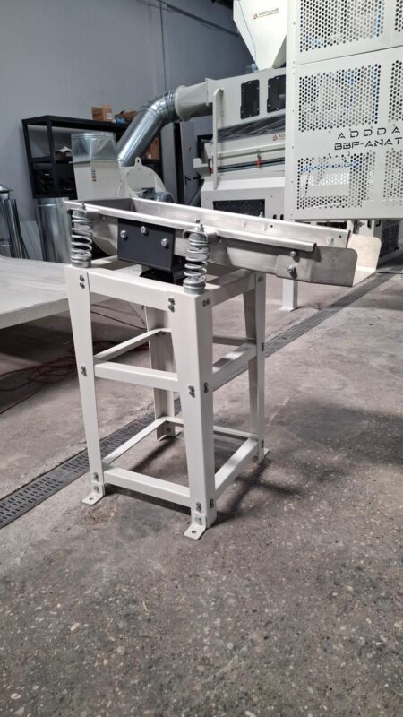 Spring-mounted ADDAMS vibratory feed tray on a steel support frame