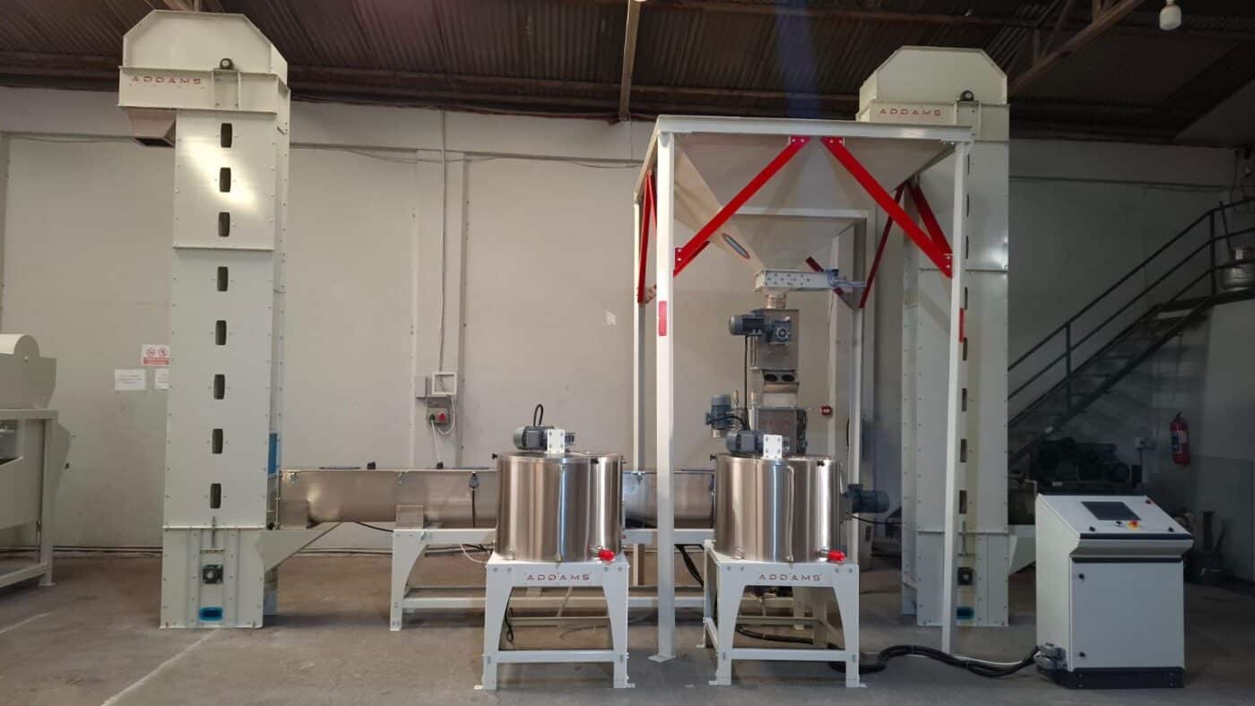 ADDAMS processing line in the workshop with bucket elevators, hoppers, conveyors and control panel